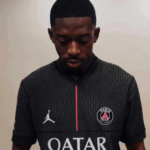 A Man Wearing A Black Shirt That Says Qatar GIF