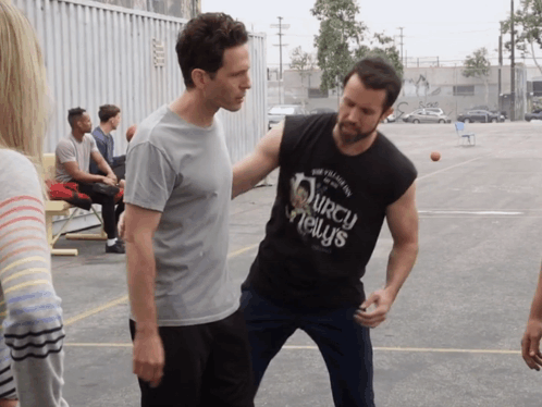 A Man Wearing A Black Shirt That Says ' Squirrel News ' GIF