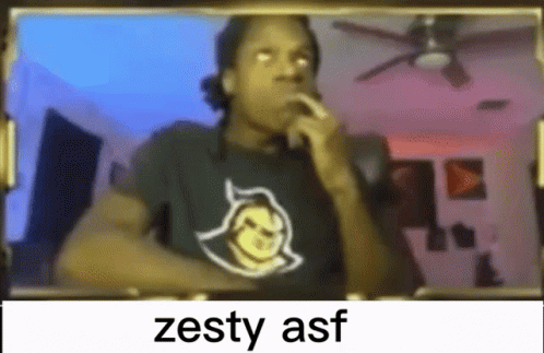 A Man Wearing A Black Shirt With A Devil On It Is Smoking A Cigarette In Front Of A Mirror . GIF
