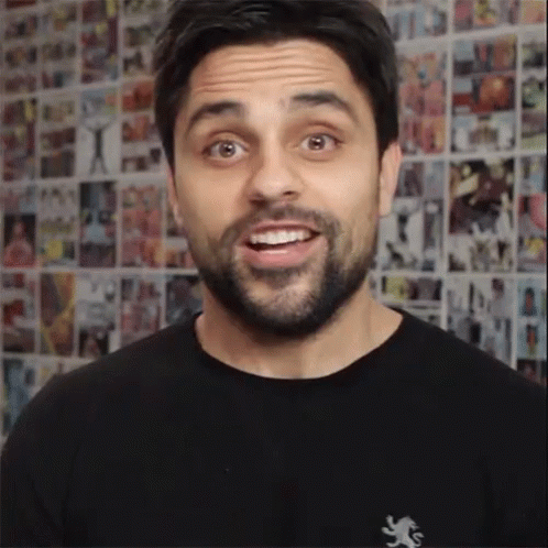 A Man Wearing A Black Shirt With A Lion On It GIF