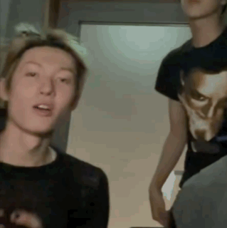 A Man Wearing A Black Shirt With A Picture Of A Man On It GIF