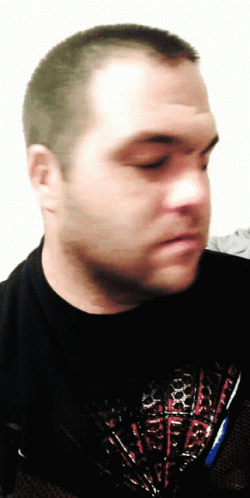 A Man Wearing A Black Shirt With A Red White And Blue Design GIF