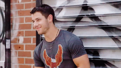 A Man Wearing A Black Shirt With An Eagle On It GIF