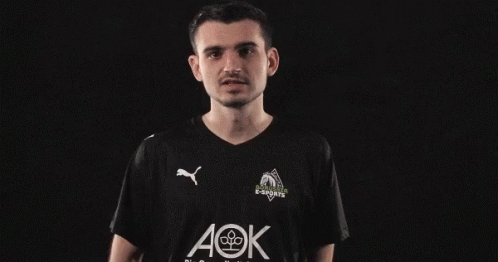 a man wearing a black shirt with aok written on it