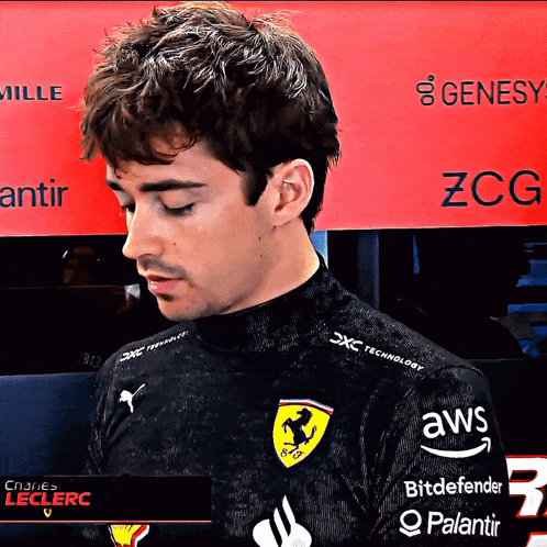 A Man Wearing A Black Shirt With Ferrari On It GIF