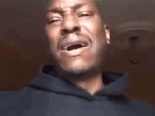 A Man Wearing A Black Shirt With Pink Letters That Says Shayla On It GIF