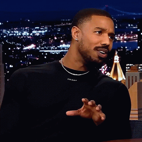 A Man Wearing A Black Shirt With Prada On It GIF