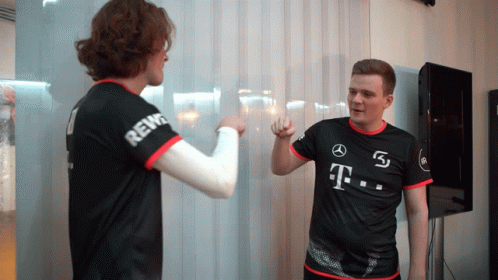 A Man Wearing A Black Shirt With T On It GIF
