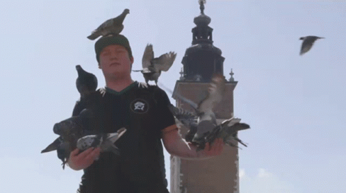 A Man Wearing A Black Shirt With The Letter A On It GIF