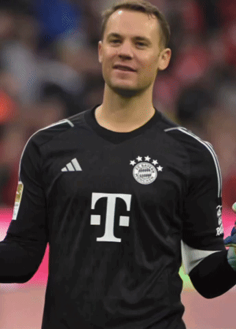 a man wearing a black shirt with the letter t on the front