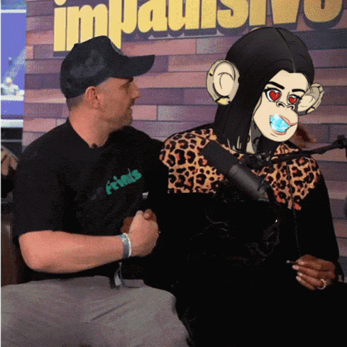 A Man Wearing A Black Shirt With The Word Friends On It Is Sitting Next To A Woman Wearing A Monkey Mask GIF