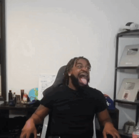 A Man Wearing A Black Shirt With The Word La On It Sticks His Tongue Out GIF
