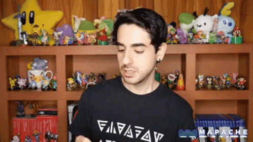A Man Wearing A Black Shirt With The Word Mapache On The Front GIF