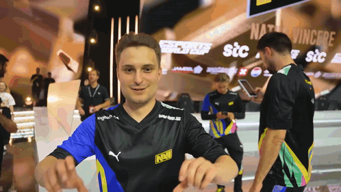 A Man Wearing A Black Shirt With The Word Navi On The Front GIF
