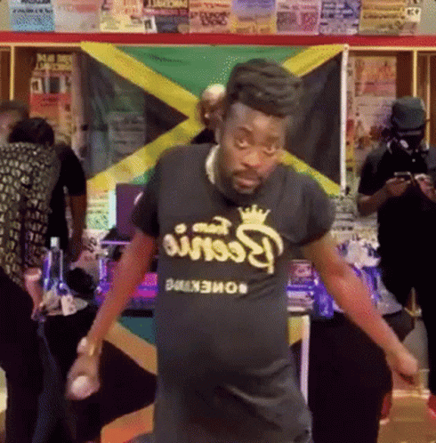 A Man Wearing A Black T-Shirt That Says Reese 'S Peanut Butter GIF