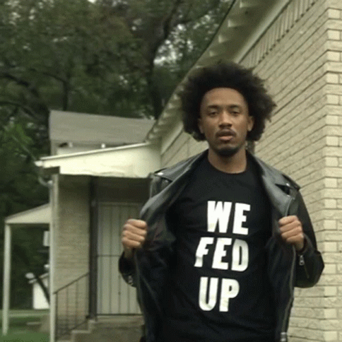 A Man Wearing A Black T-Shirt That Says We Fed Up GIF