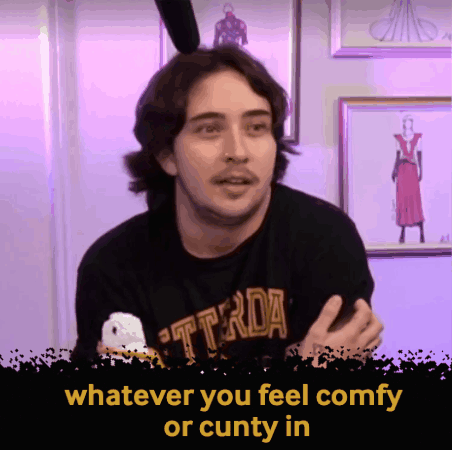 a man wearing a black t-shirt that says ' whatever you feel comfy or cunty in '