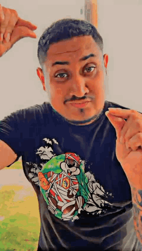 A Man Wearing A Black T-Shirt With A Picture Of A Mummy Bear On It GIF