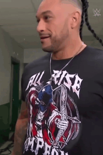 A Man Wearing A Black T-Shirt With A Skeleton On It . GIF