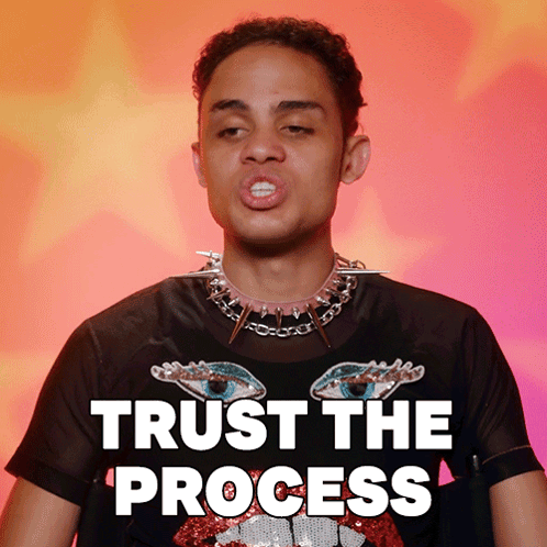 A Man Wearing A Black T-Shirt With Spikes Around His Neck Says " Trust The Process " GIF