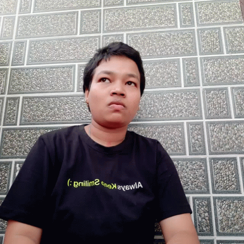 A Man Wearing A Black T-Shirt With The Letters Gnilm2 On It GIF
