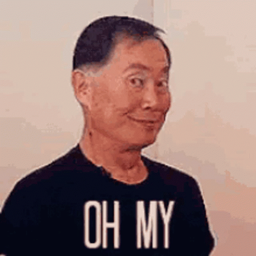 A Man Wearing A Black T-Shirt With The Words `` Oh My '' On It Is Making A Funny Face . GIF
