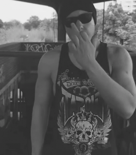 A Man Wearing A Black Tank Top That Says Driven To Be GIF