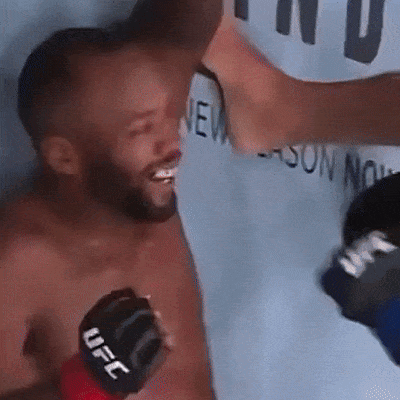 A Man Wearing A Black Ufc Glove Is Being Punched In The Face GIF