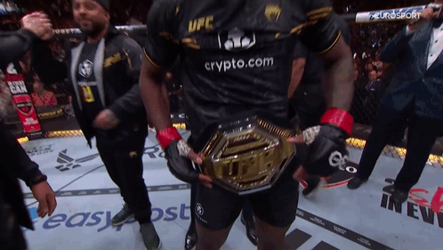 A Man Wearing A Black Ufc Shirt Holds A Gold Belt GIF