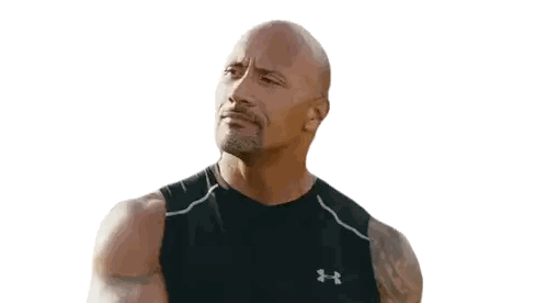 a man wearing a black under armour tank top looks to the side