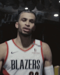 A Man Wearing A Blazers Jersey Stands In The Dark GIF