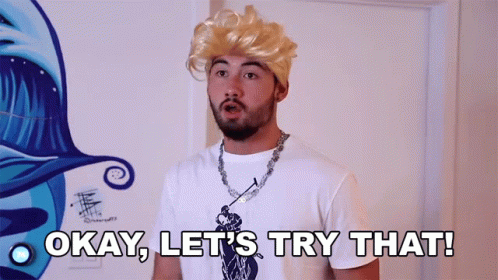 A Man Wearing A Blonde Wig And A White Shirt Says Okay Let 'S Try That GIF