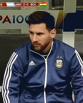 A Man Wearing A Blue Adidas Jacket Sits In A Locker Room GIF