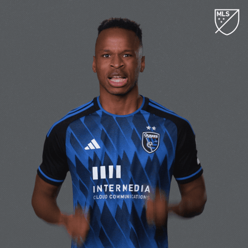 A Man Wearing A Blue And Black Jersey With The Words Let 'S Go On It GIF
