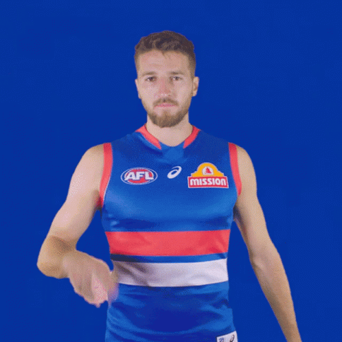 A Man Wearing A Blue And Red Afl Jersey With Mission Written On It GIF