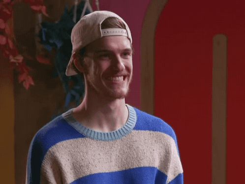 A Man Wearing A Blue And White Striped Sweater And A White Hat GIF
