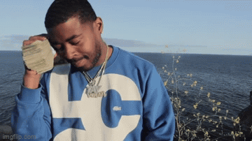 A Man Wearing A Blue And White Sweatshirt With The Letter L On It GIF