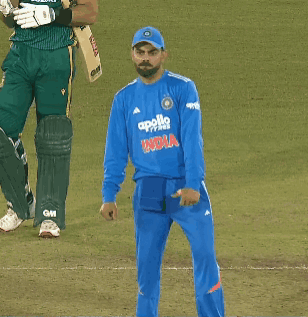 A Man Wearing A Blue Apollo India Jersey Stands On A Field GIF