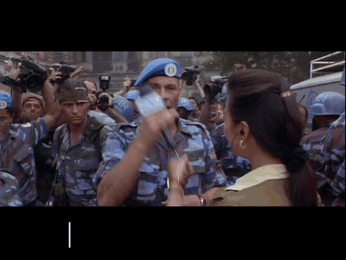 A Man Wearing A Blue Beret With The Number 10 On It GIF