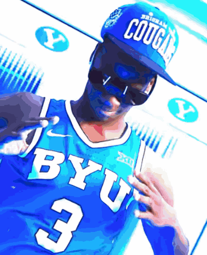 A Man Wearing A Blue Byu Jersey And A Blue Cougars Hat GIF
