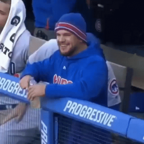 A Man Wearing A Blue Cubs Sweatshirt Sits In The Stands GIF