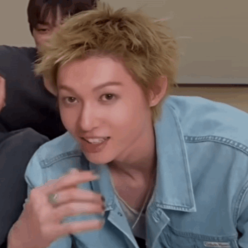 A Man Wearing A Blue Denim Jacket Has A Ring In His Finger GIF