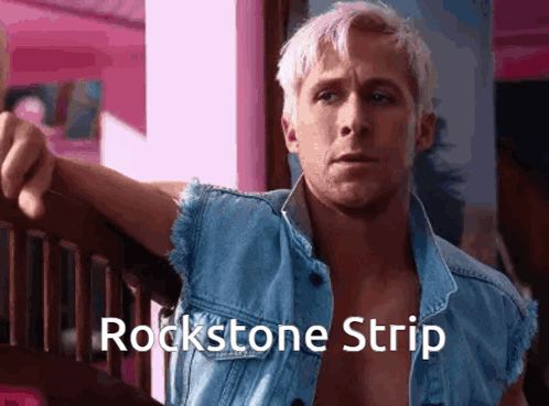 A Man Wearing A Blue Denim Vest With The Words Rockstone Strip On It GIF