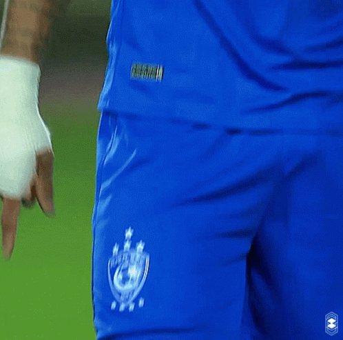 A Man Wearing A Blue Emaar Jersey Looks To His Left GIF