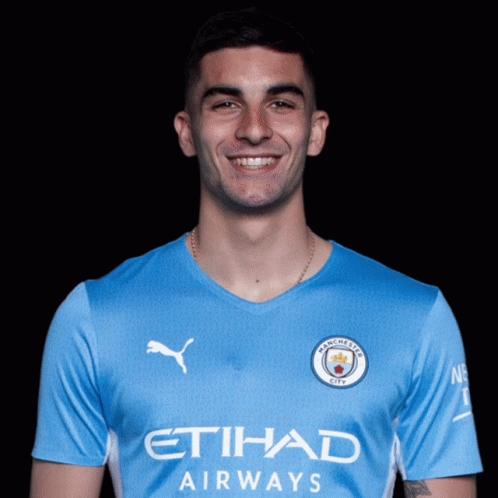 A Man Wearing A Blue Etihad Airways Jersey GIF