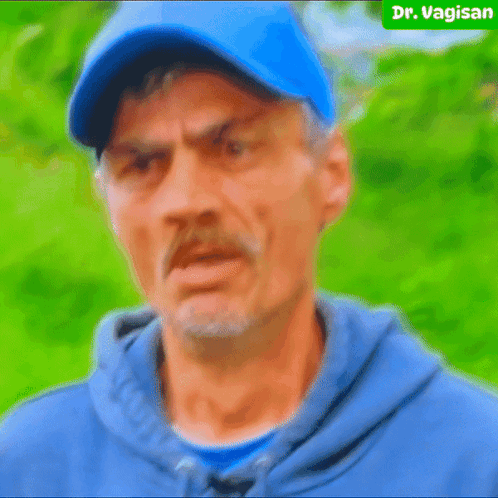 Man In Blue Hat And Hoodie Looks Angry GIF