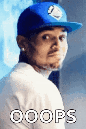 A Man Wearing A Blue Hat And A White Shirt Has The Word Oops Written Below Him GIF