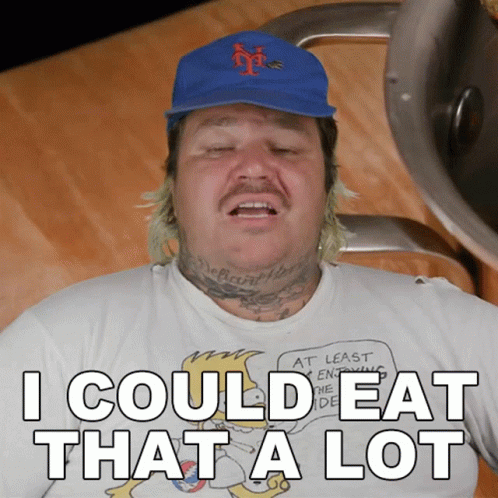 A Man Wearing A Blue Hat And A White Shirt That Says I Could Eat That A Lot GIF