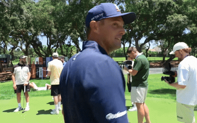 A Man Wearing A Blue Hat That Says New York Is Standing On A Golf Course GIF