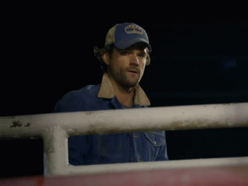 a man wearing a blue hat that says texas on it